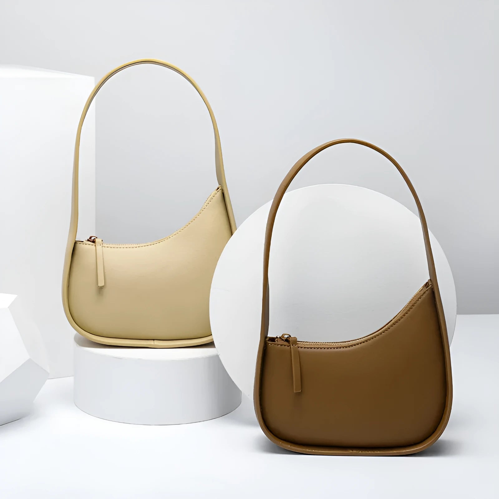Small half moon leather ladies shoulder bag with wide strap in caramel colour