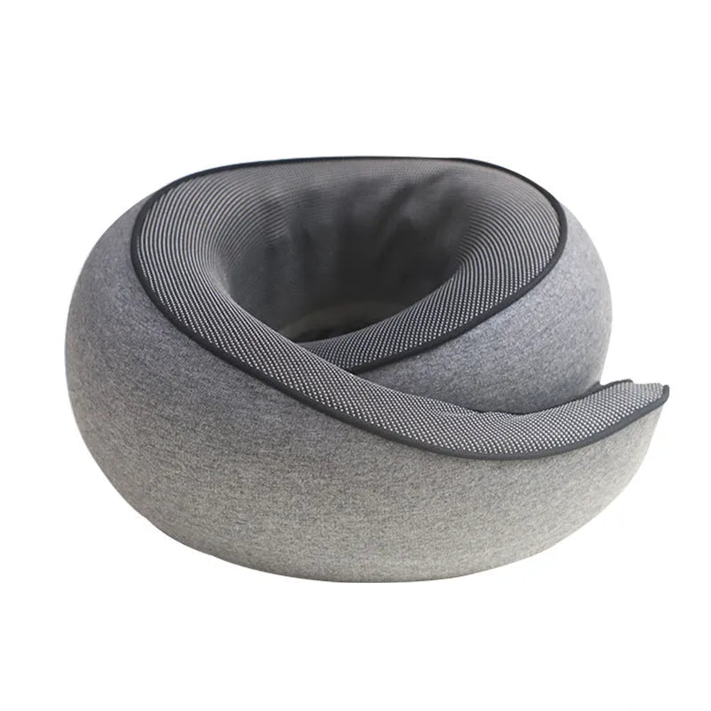 Black memory foam U-shaped travel neck pillow with a storage bag, shown for scale.