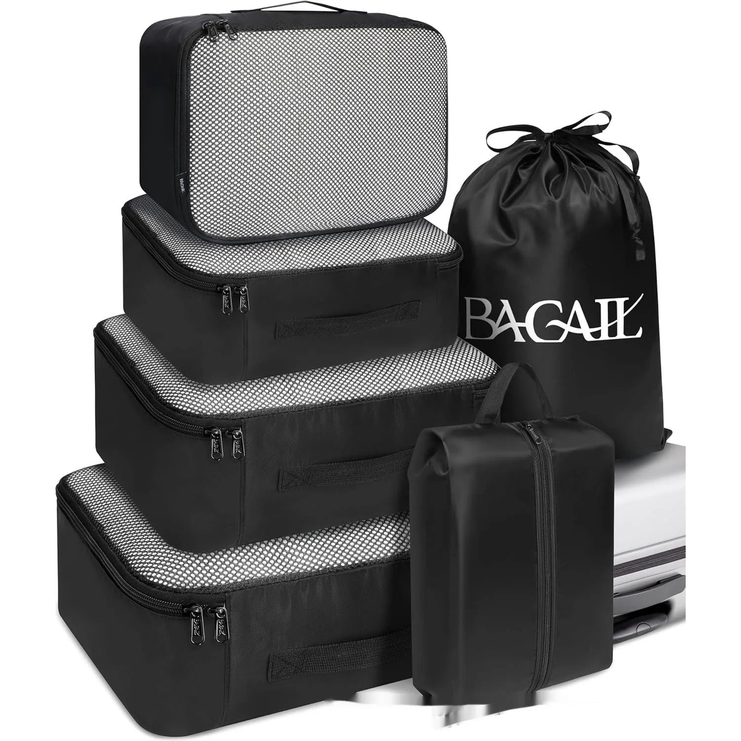 Cubic eight-piece travel packing set showing compression bags in various colours including beige, black, and pink leopard print
