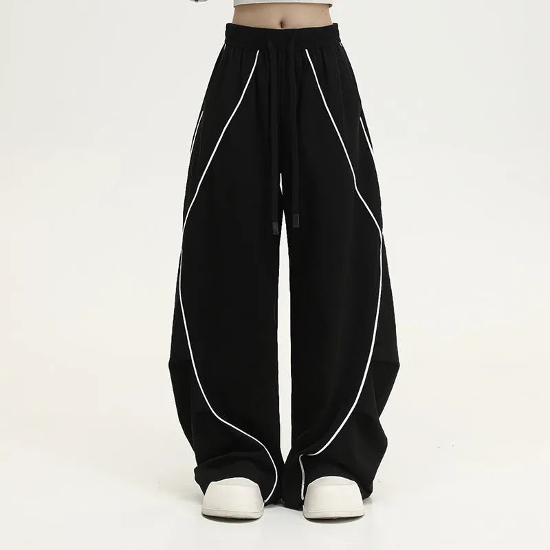 Black pleated wide-leg hip hop pants with striped pattern and mid-waist design made of polyester