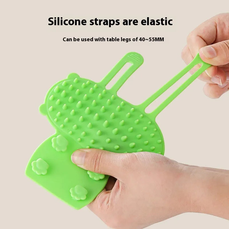 Silicone pet grooming comb with adjustable strap mounted on table leg for cats and dogs
