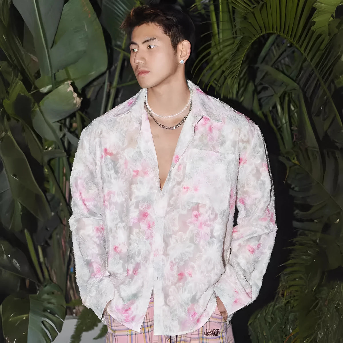 Man wearing a blue floral embossed long sleeve shirt with a loose fit