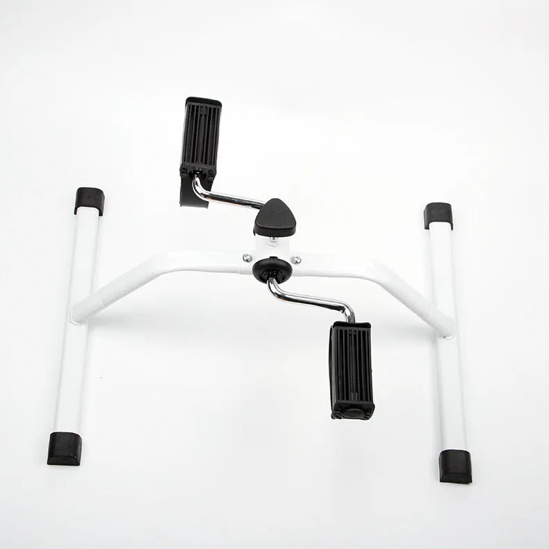 White mini exercise bike with mechanical resistance, non-slip pedals, rubber feet and 150kg maximum load
