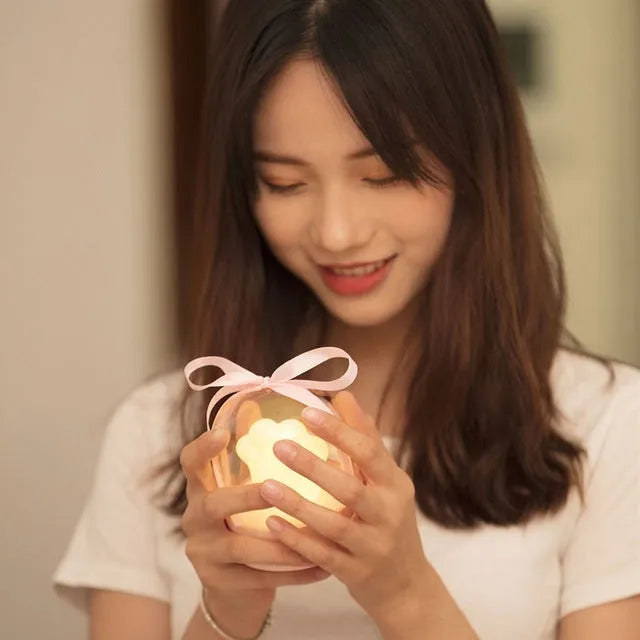Grey cat paw shaped night light with USB charging cable and adjustable brightness controls