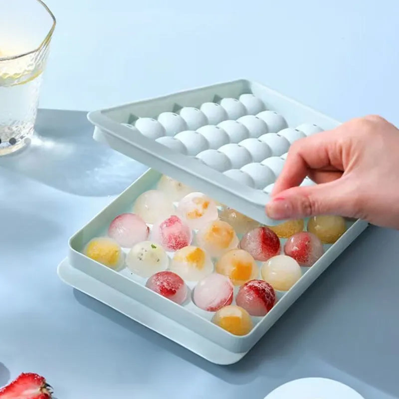 Blue silicone ice cube tray with lid showing 33 round grids for ice making