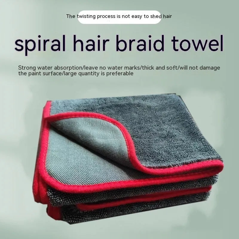Grey car wash towel with black trim edge, showing hemmed border and spiral hair texture.