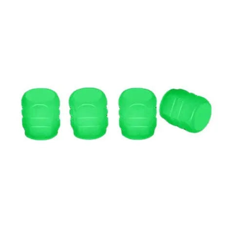Set of luminous rubber tyre valve caps in assorted colours on a car wheel valve stem.