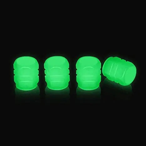Set of luminous rubber tyre valve caps in assorted colours on a car wheel valve stem.