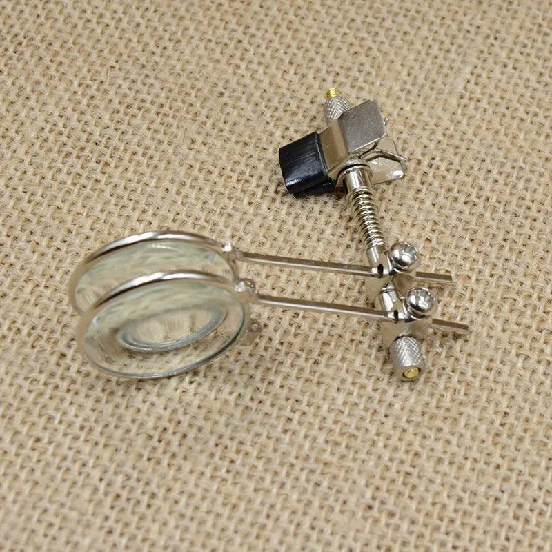 Metal and glass reading glass mirror with double clip for attaching to spectacles.
