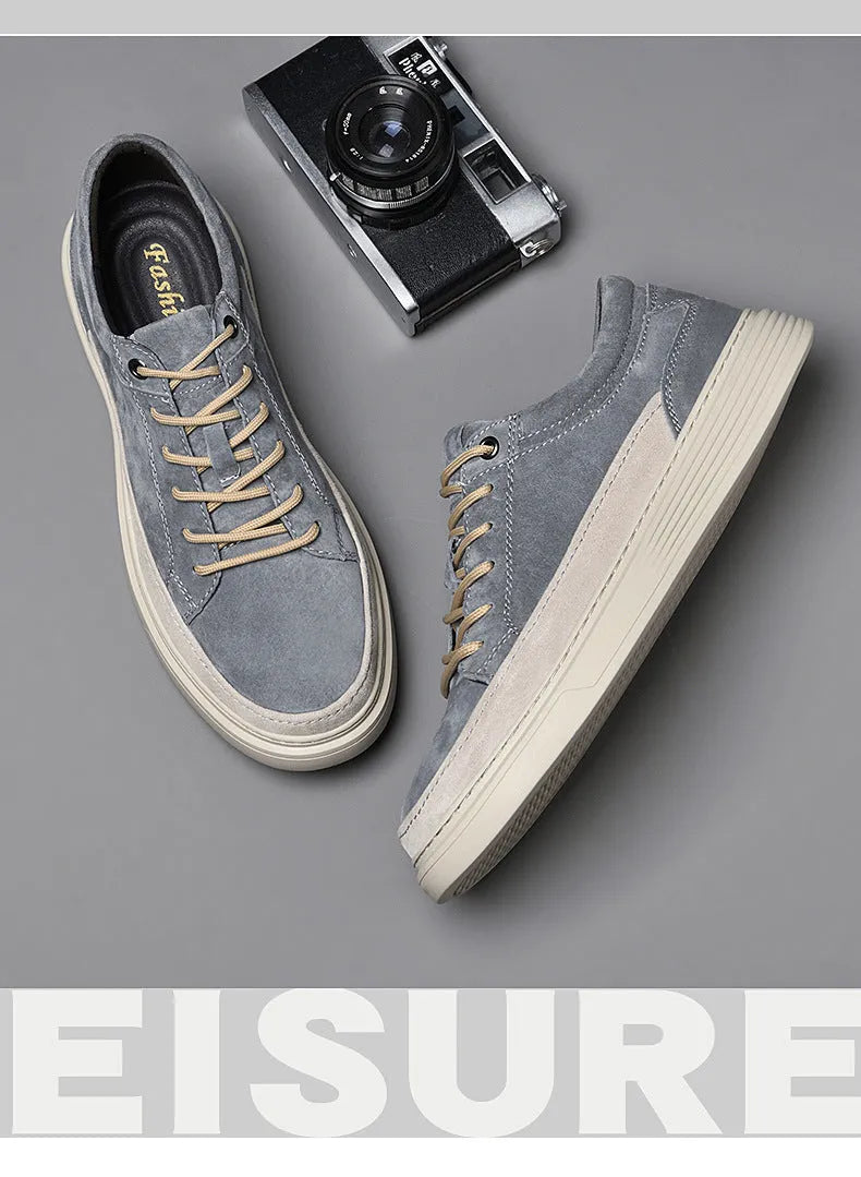 Men's grey casual leather skate shoes with round toe and lace-up front on a rubber sole.