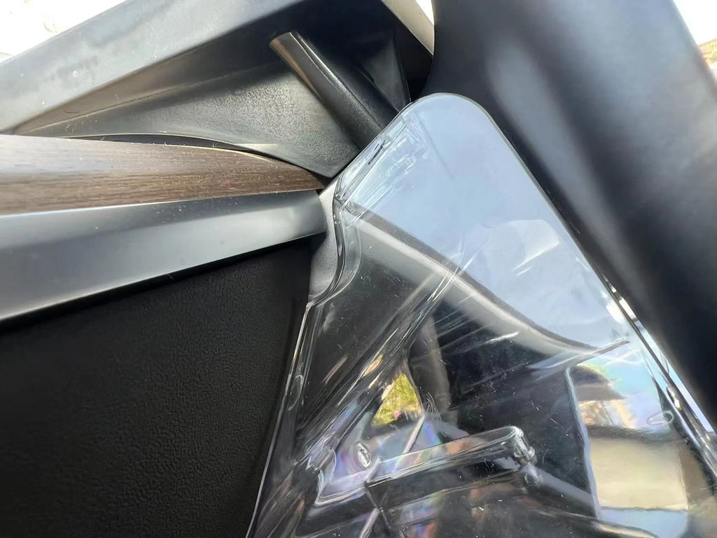 Black ABS plastic storage box installed under the touchscreen in a Tesla Model Y centre console.