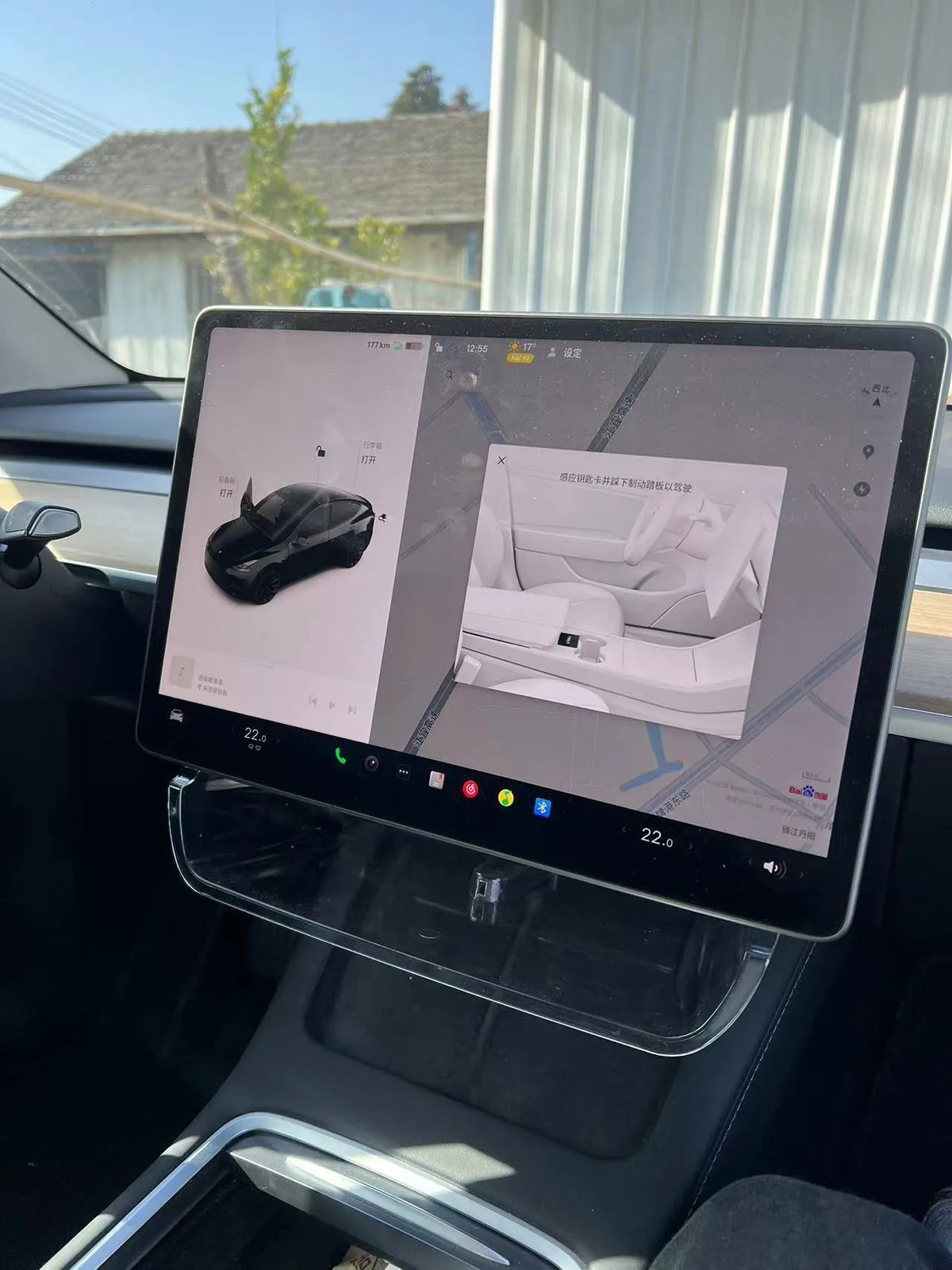 Black ABS plastic storage box installed under the touchscreen in a Tesla Model Y centre console.