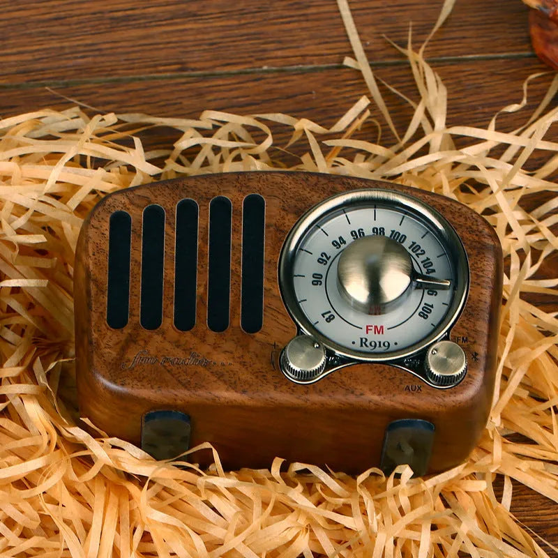 Retro wooden mini Bluetooth speaker in cherry wood finish showing front grille and wooden casing