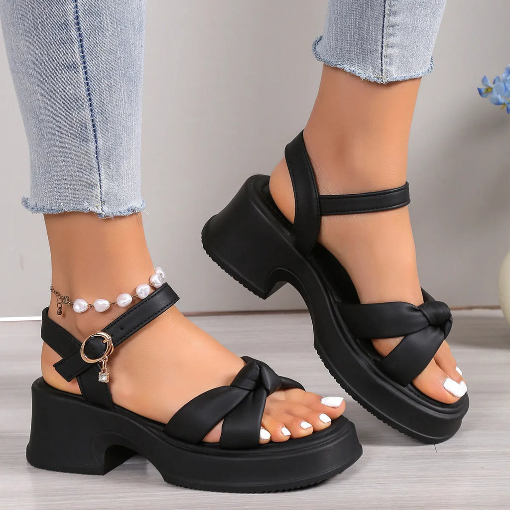 Black high heel slippers with thick rubber sole and button fastening on round toe design