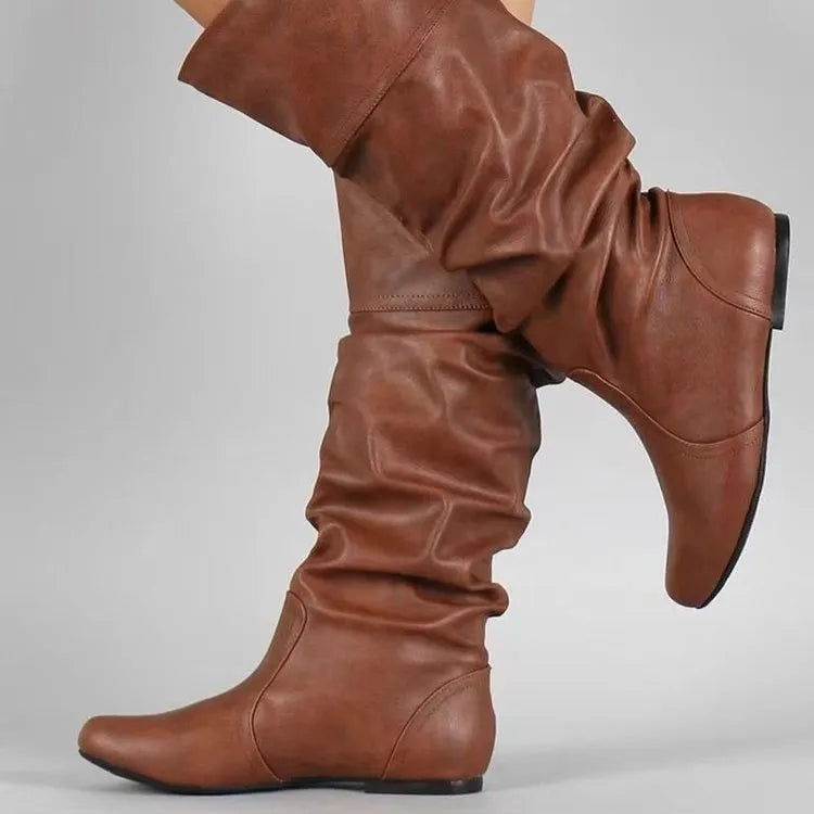Women's flat heel slip-on ankle boot in artificial PU leather with a round toe and high cylinder sock.