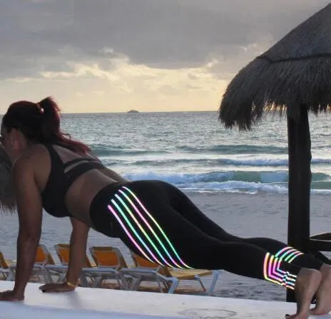 Women's black fitness leggings with reflective print pattern for night workouts