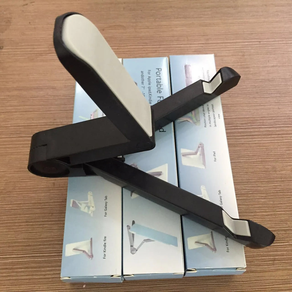 Black foldable aluminium tablet holder showing adjustable angles and flat-folded profile