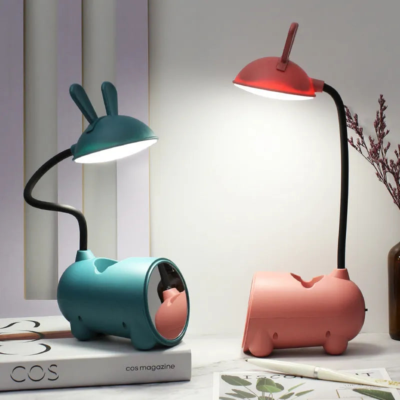 Cartoon-style USB desk lamp with pen storage compartment in green, blue, or pink colour options