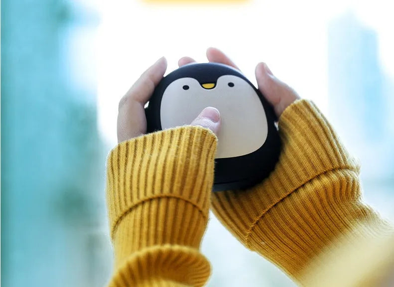 Cute cartoon penguin polar bear design USB rechargeable hand warmer and power bank unit.