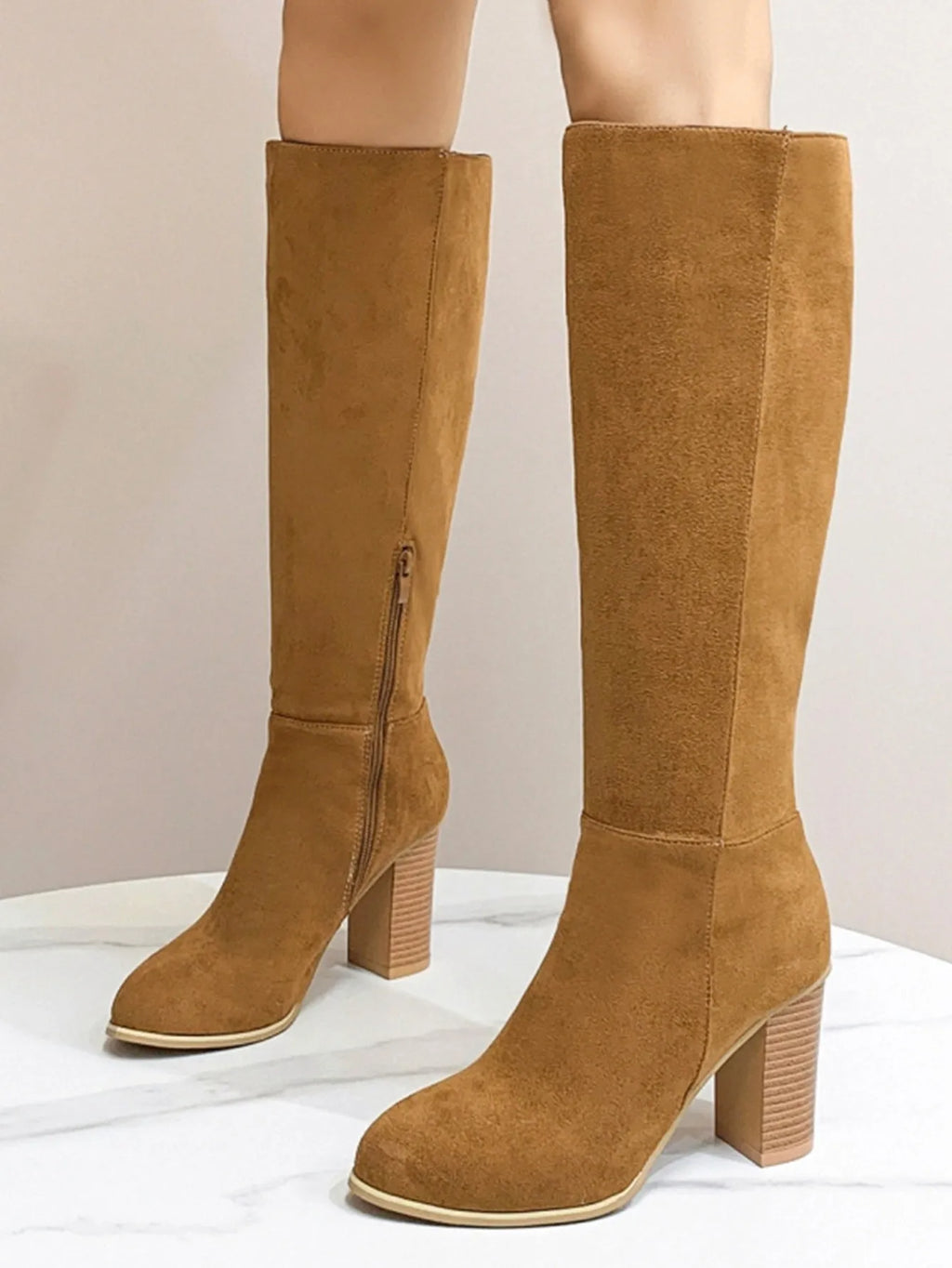 Black square toe high heel fashion boots for women on a white background.