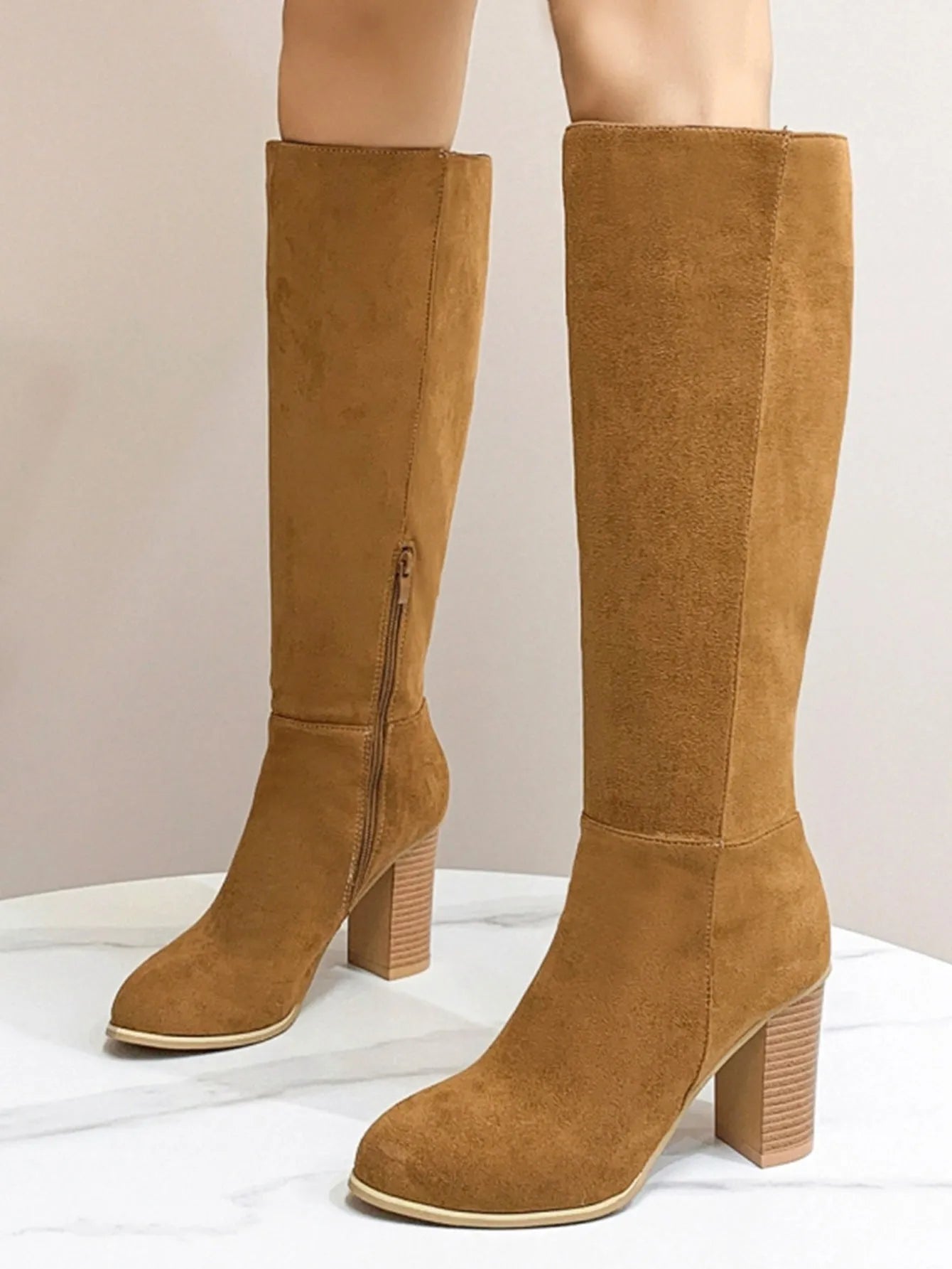 Black square toe high heel fashion boots for women on a white background.