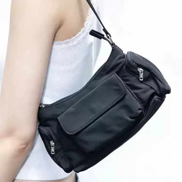 Black double pocket shoulder bag with side line detailing showing interior organisation
