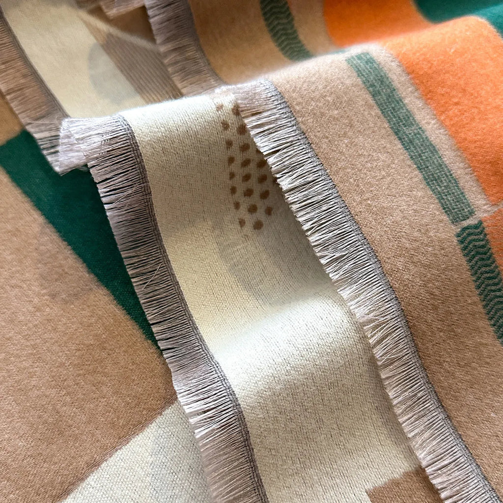 A long beige imitation cashmere scarf draped to show its 185cm length and texture.