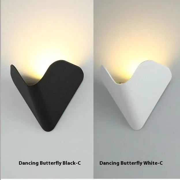 Black bird's nest design LED courtyard lamp with IP65 waterproof rating on a garden wall.