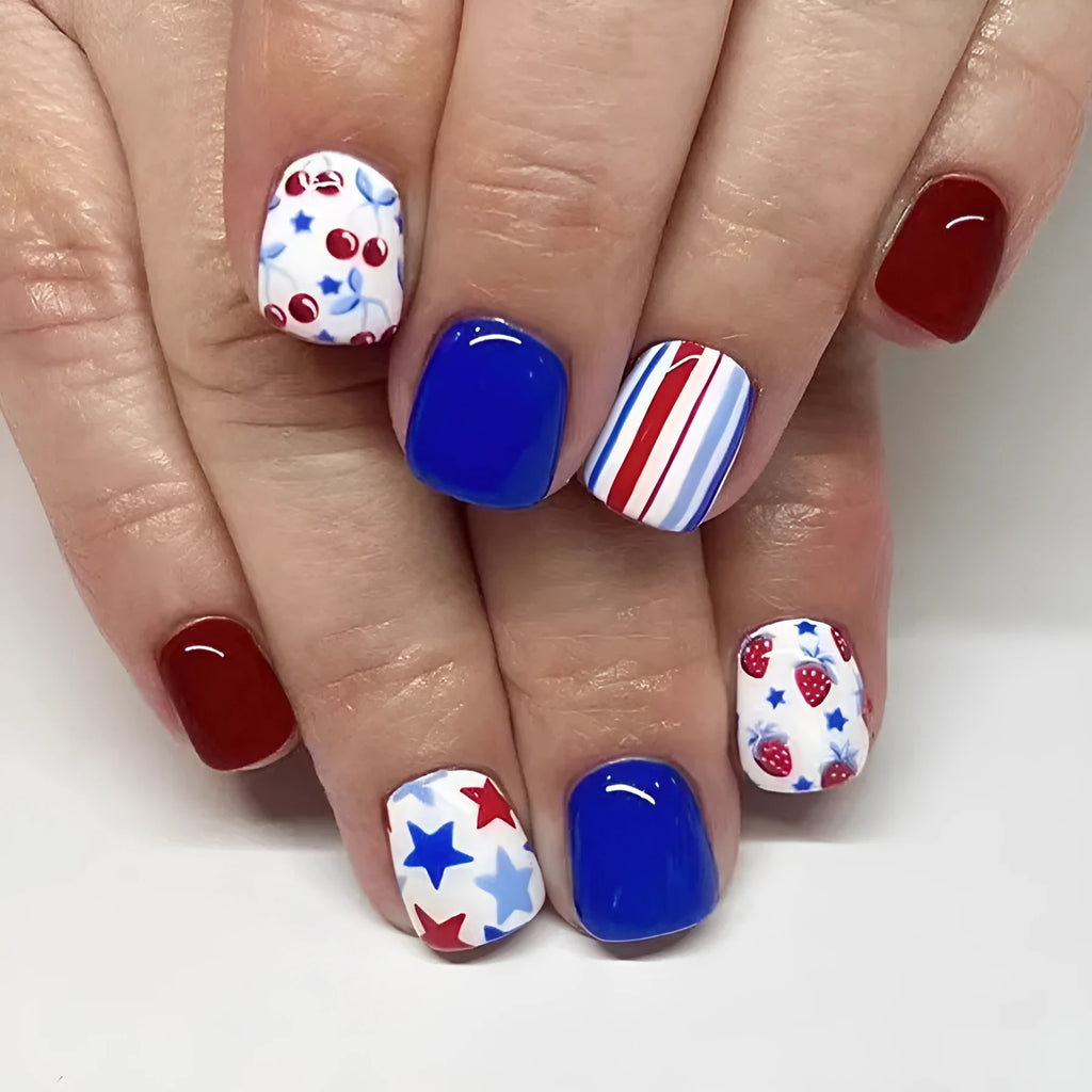 Short glossy press-on nails with strawberry and cherry图案 in red and blue colours