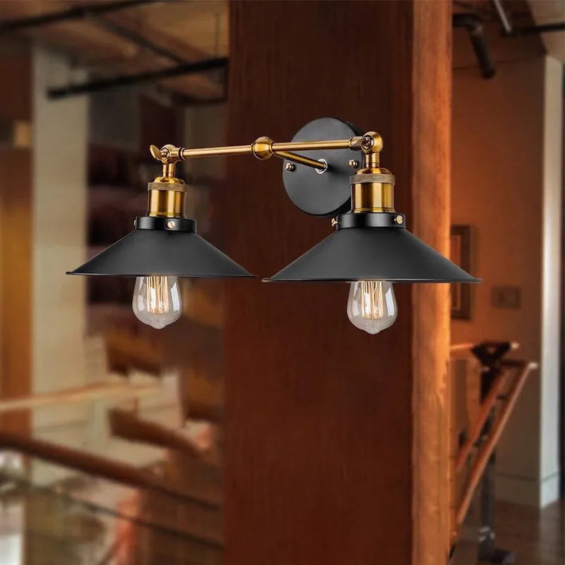 Black double head American retro industrial style iron wall lamp mounted on a wall.