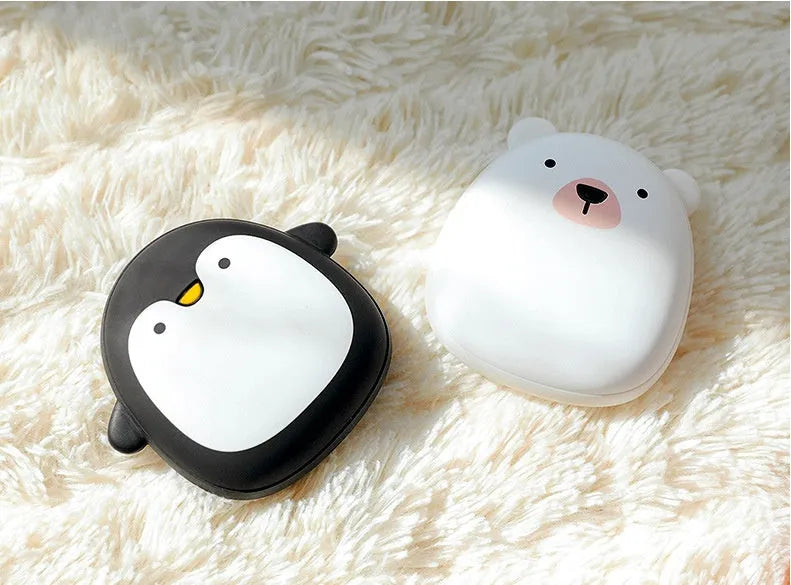 Cute cartoon penguin polar bear design USB rechargeable hand warmer and power bank unit.
