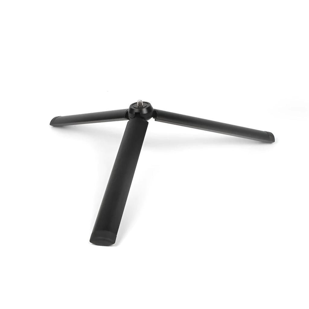 Black aluminium mobile phone tripod stabilizer with PTZ functionality on a table