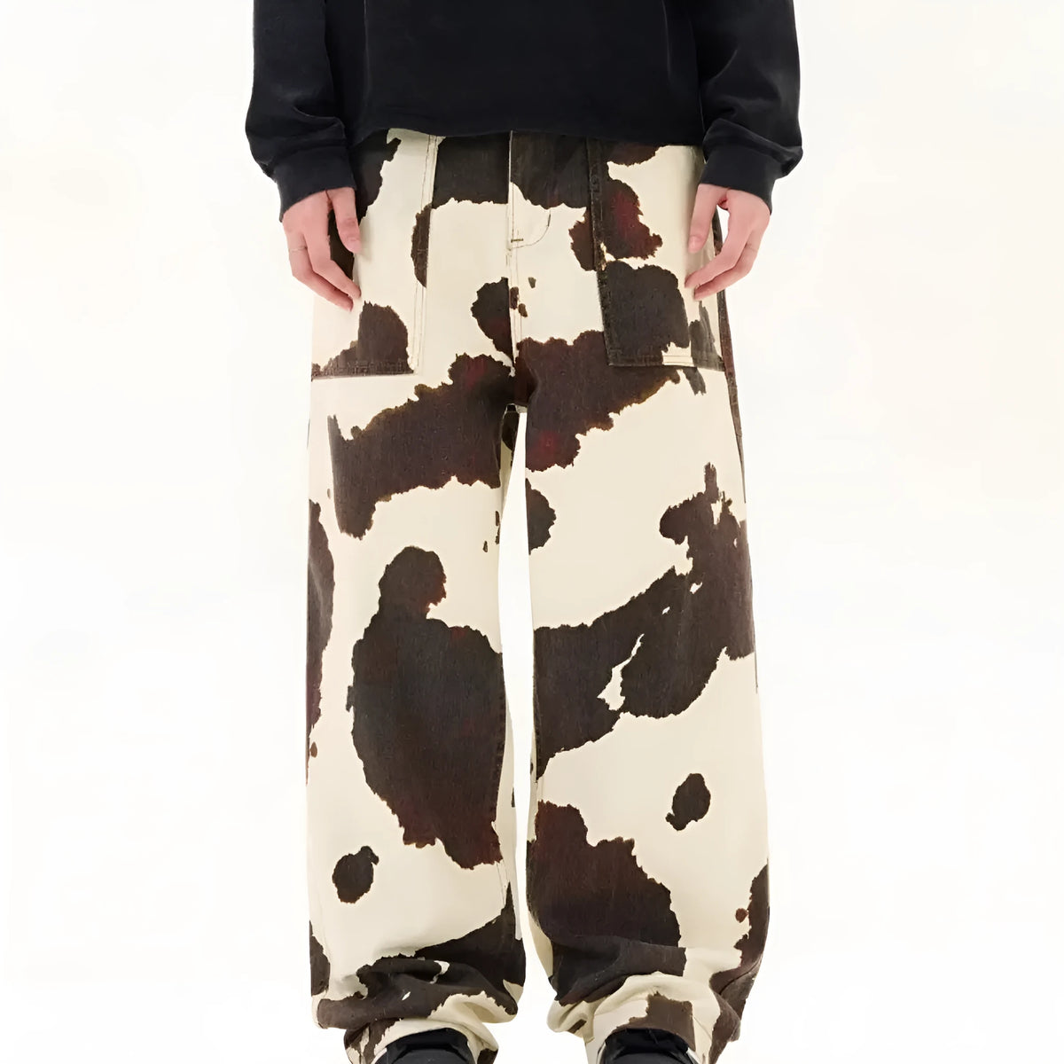 Men's straight-leg casual trousers with a blue and white American retro cow print pattern, showing button fly detail.