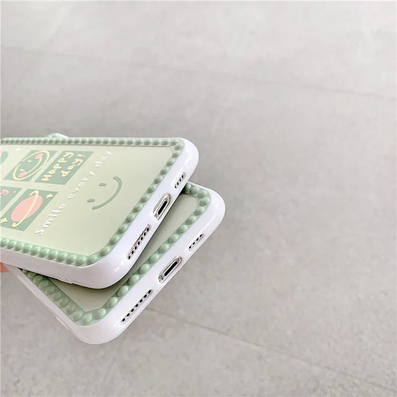 Green TPU iPhone case with smiley face and geometric pattern inside a polka dot frame.