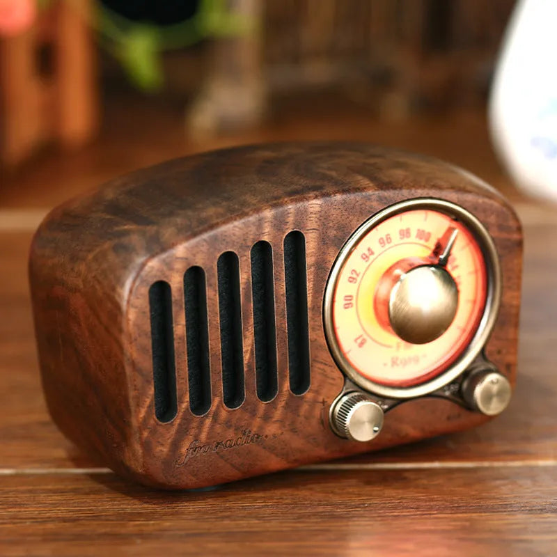 Retro wooden mini Bluetooth speaker in cherry wood finish showing front grille and wooden casing