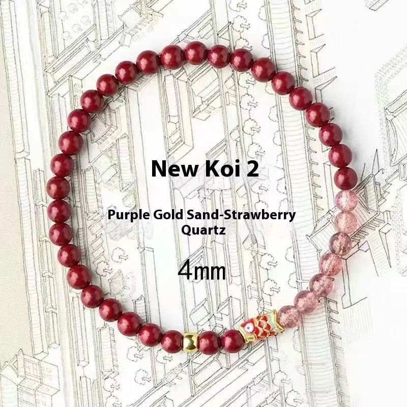 Purple cinnabar and strawberry quartz bracelet with peach blossom and koi charms on a wrist.