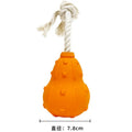 Natural rubber stuffable dog toy with a long strap for fetch, shown with treats inside the hollow centre.