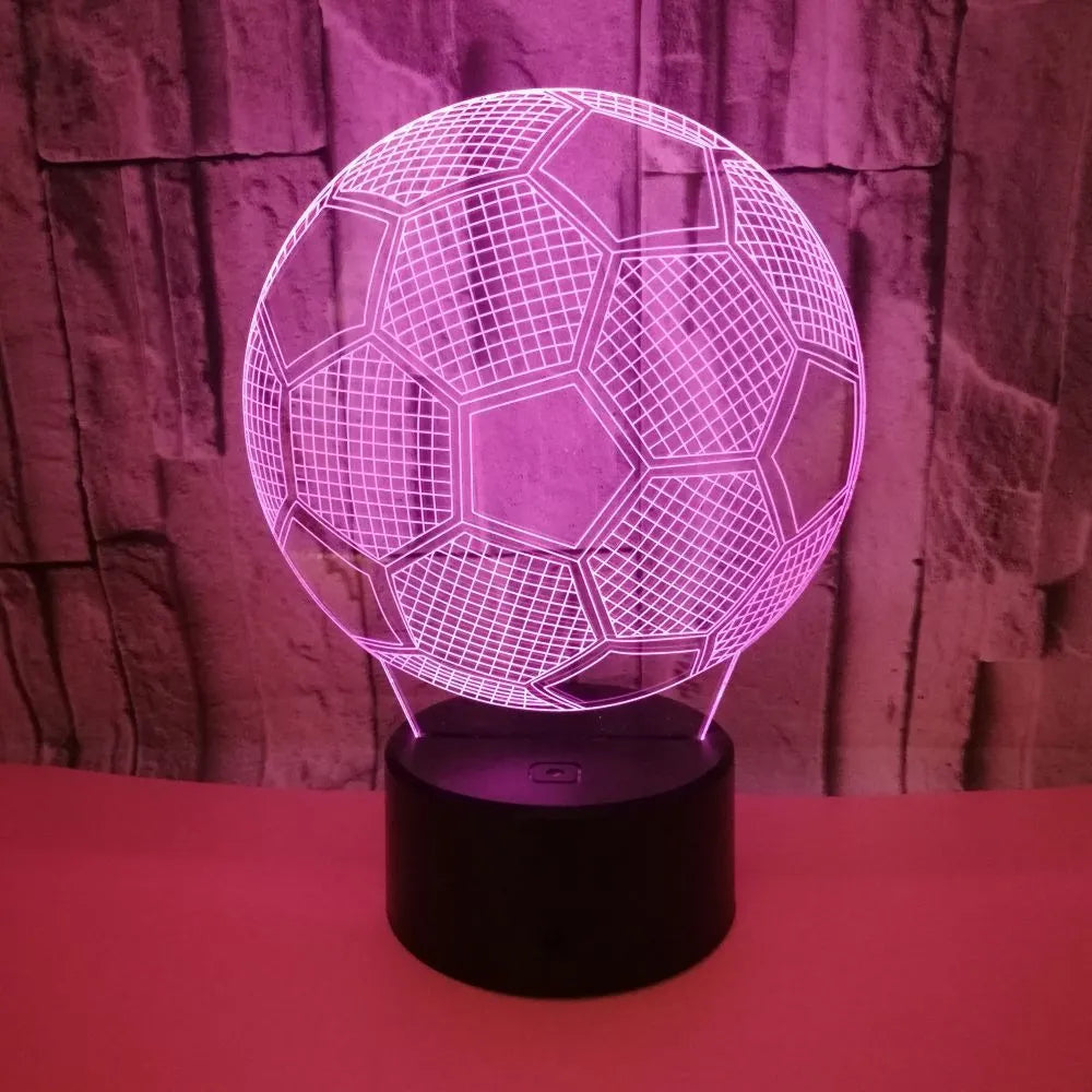 3D football-shaped acrylic night light displaying blue LED colour on a black ABS base.