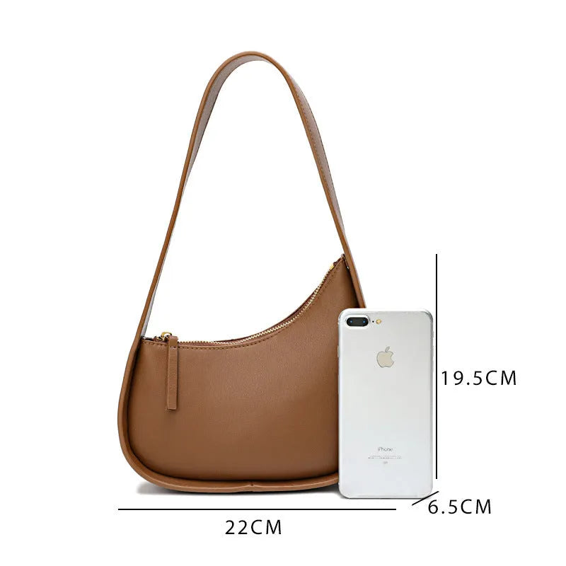 Small half moon leather ladies shoulder bag with wide strap in caramel colour