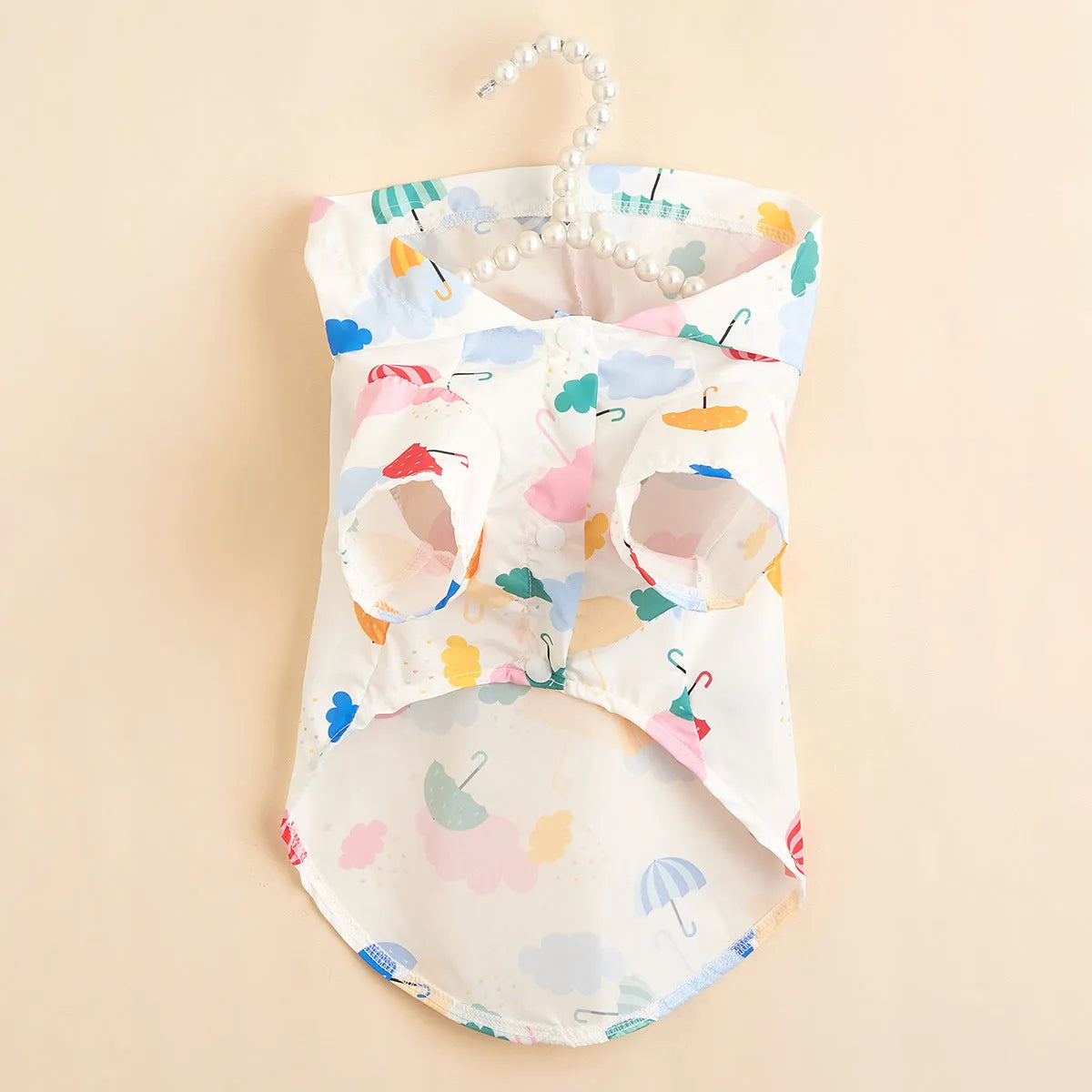 Colourful cartoon umbrella pattern dog raincoat in size L on a mannequin.
