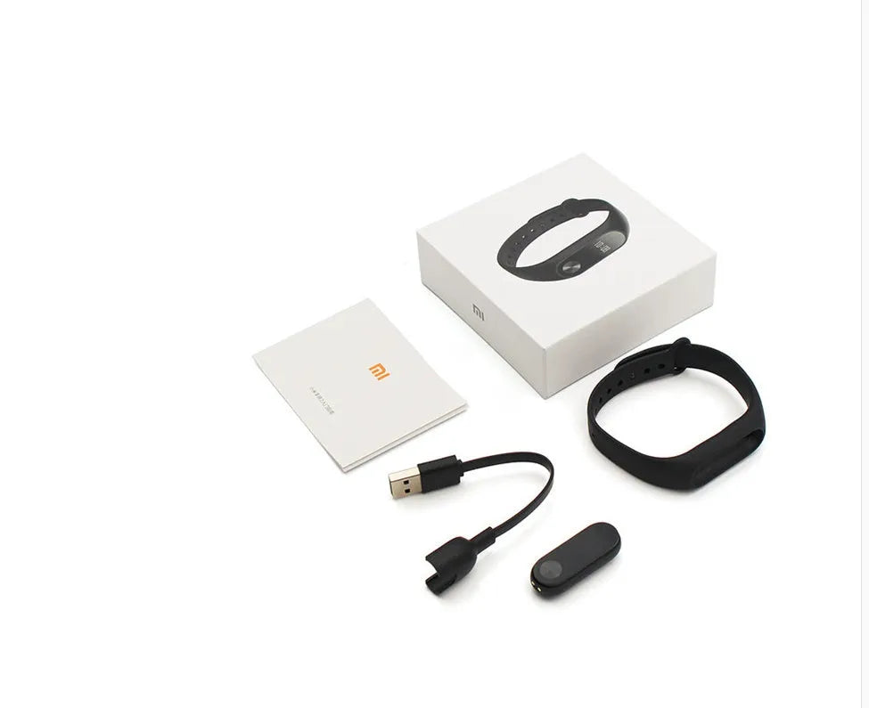 Black Xiaomi Mi Band 2 fitness tracker with OLED screen on an adjustable thermoplastic wrist strap.