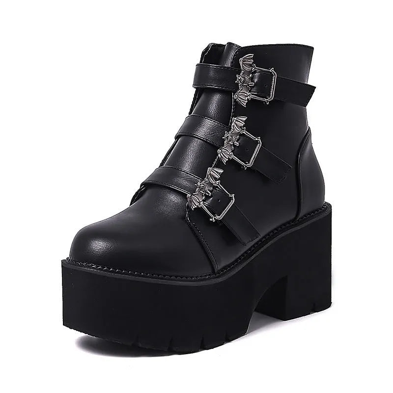 Black women's punk style short boots with bat buckle, thick heel, and side zipper.