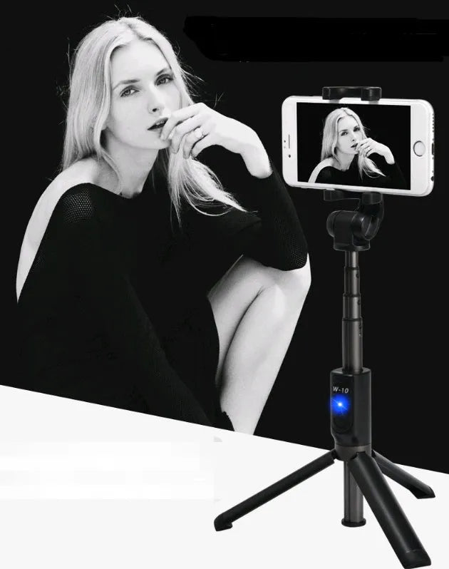 Bluetooth selfie stick tripod with remote control extended with smartphone attached