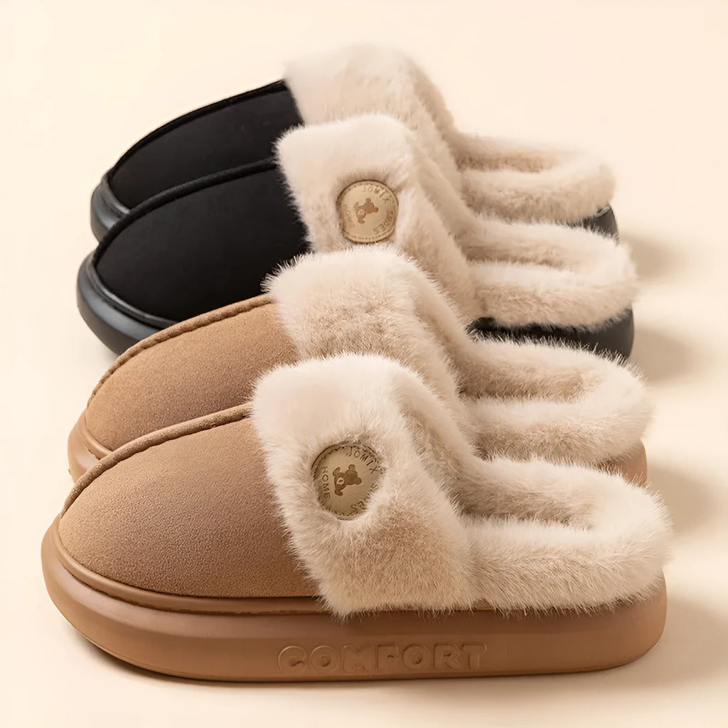 Pair of thick-soled plush fleece slippers in brown with car stitching detail on the upper.