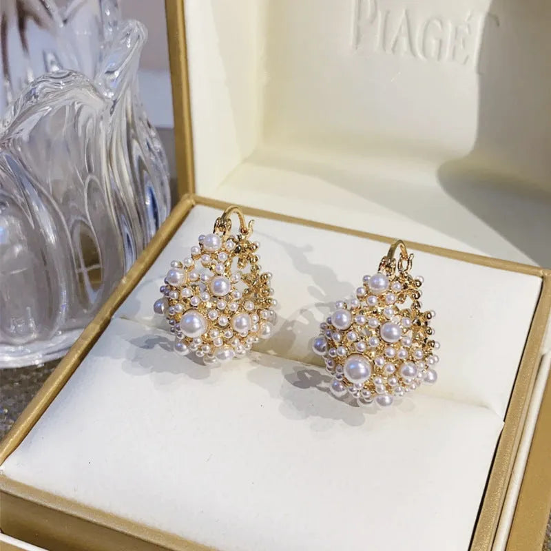 Gold-coloured women's flower basket earrings with small rice-shaped beads and pearl inlay on copper.