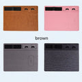 Pink multifunctional wireless charging mouse pad with integrated mobile phone holder on a desk