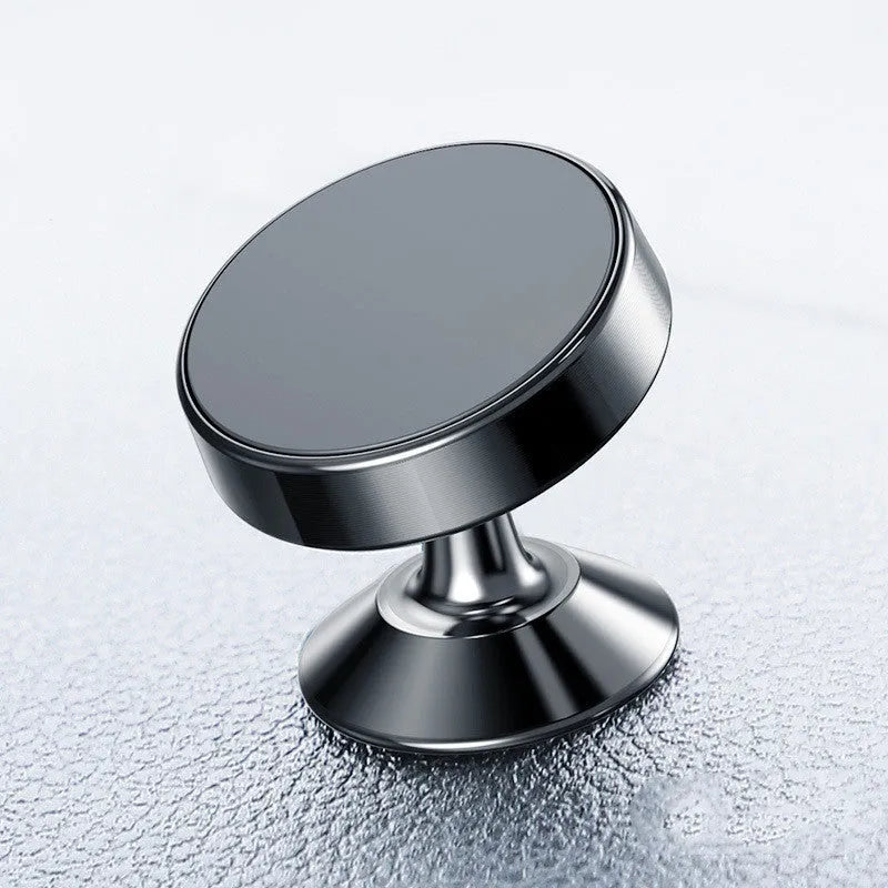 Aluminium alloy magnetic car phone holder in black, showing adhesive paste and snap-type mounting options on a car dashboard.