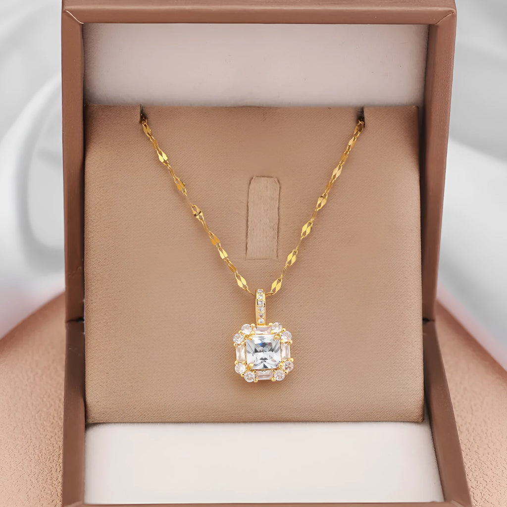 Gold geometric zircon inlaid pendant on a water wave chain necklace.