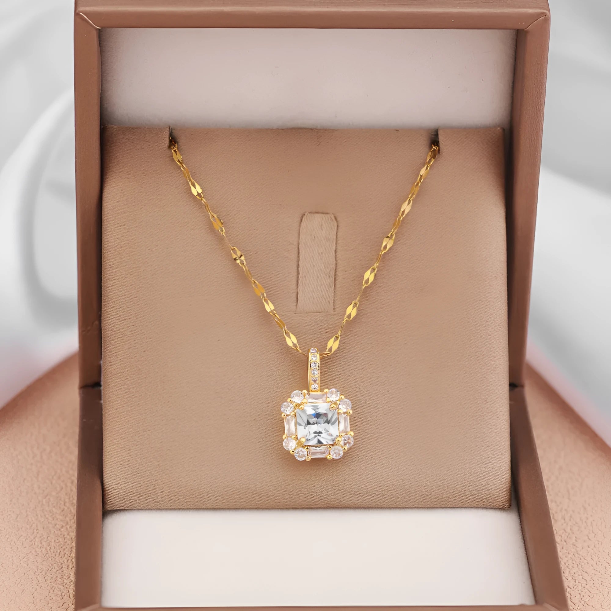 Gold geometric zircon inlaid pendant on a water wave chain necklace.