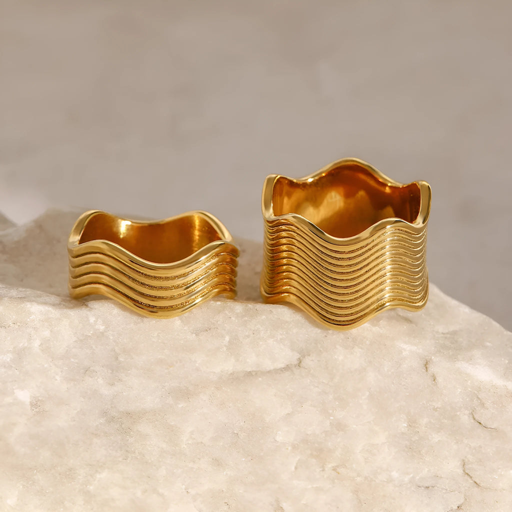 A geometric wave-design ring for women made from silver-toned stainless steel.
